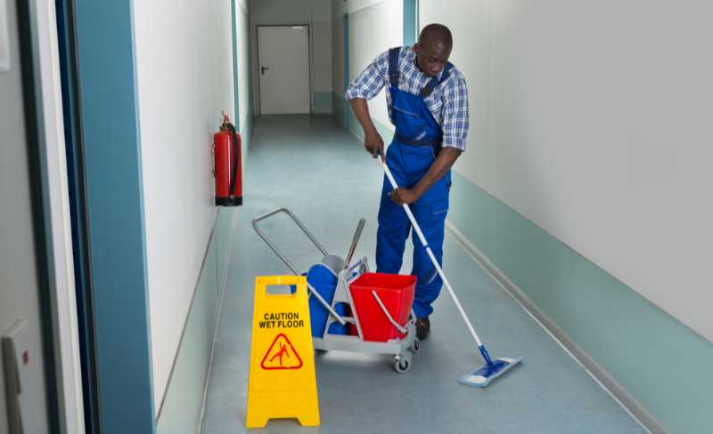 Cleaning Doctor Limited team mopping school hallways and dusting lockers for daily upkeep.