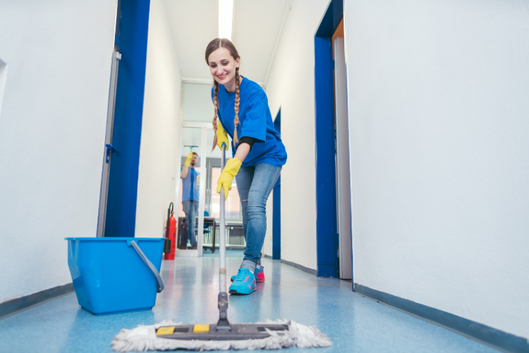 Cleaning Doctor team performing scheduled evening clean—empty workspace being vacuumed and polished for next-day use.
