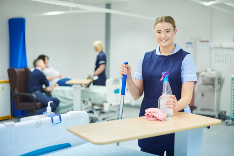 Cleaning Doctor technician sanitising reception counters, door handles, and waiting room chairs—ensuring hygienic conditions in a medical center